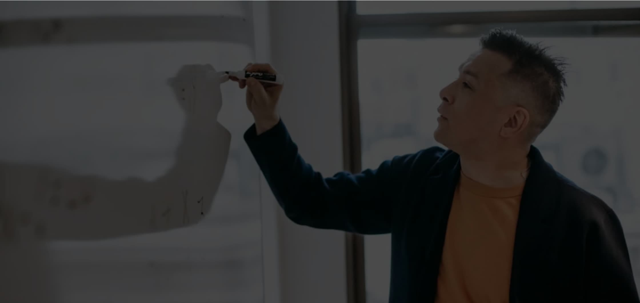 A classroom instructor at a whiteboard