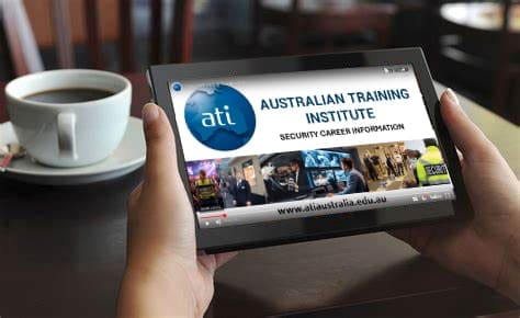 ipad-ati-sq Someones hands holding an ipad at a table with a coffee cup in the background.<br />